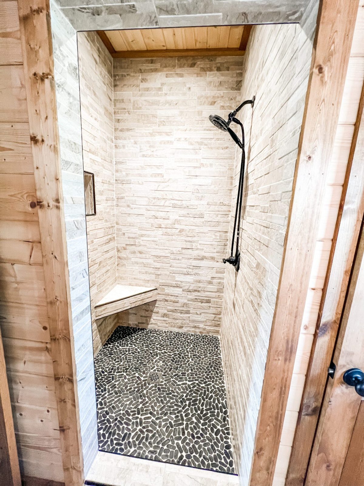 Large walk-in stone shower in the king suite bath
