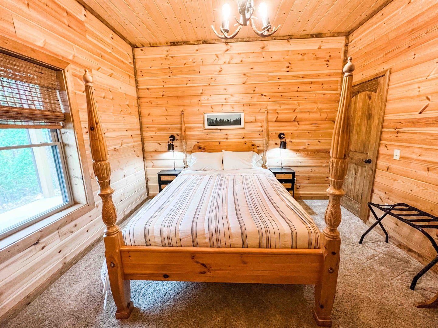 Queen bedroom with four poster bed and log walls