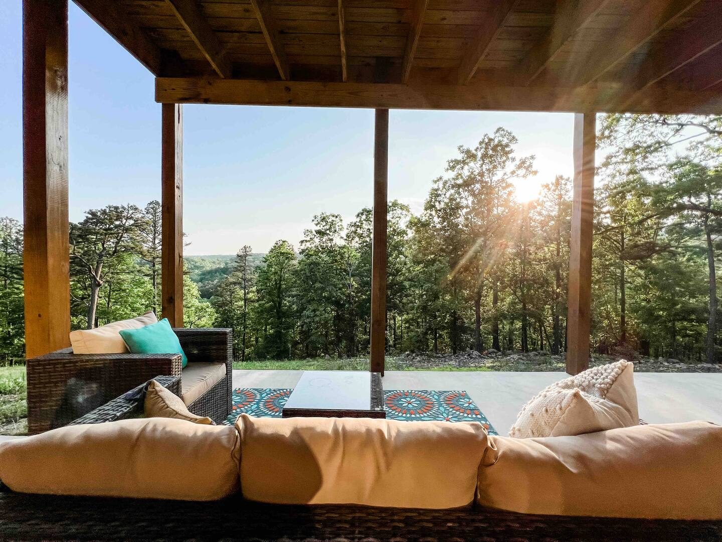 Covered porch lounge seating at sunset